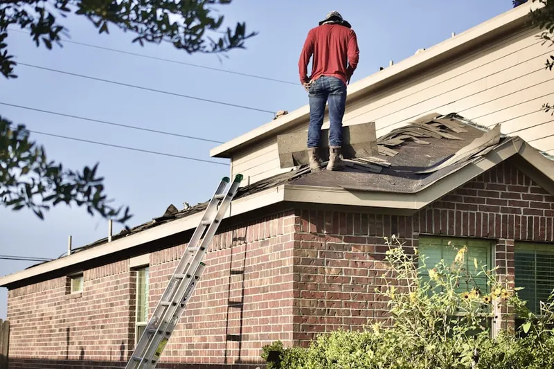 Professional roofer working on a residential roof in Sunset Lake